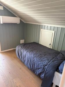 a bedroom with a bed in the middle of it at Toppen House in Ringsaker