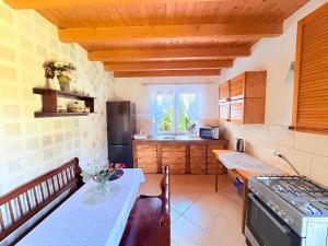 a kitchen with a table and a counter top at Wspaniały Zakątek in Sędziszowa