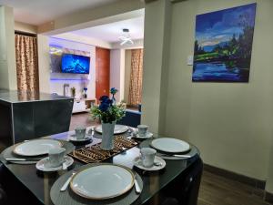 a dining room with a table with plates on it at DEPPIu in Piura