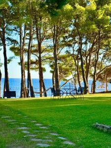 a park with benches and trees and the ocean at Ripea Suites - Sul Mare in Montecorice
