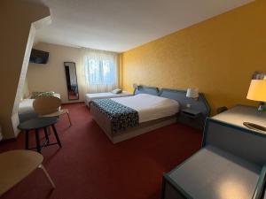 a hotel room with two beds and a table and chairs at Au Relais de l'Ill in Sermersheim +64 photos