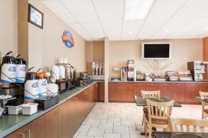 a restaurant with a counter with a coffee shop at Baymont by Wyndham Asheville/Biltmore in Asheville