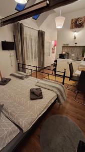 a bedroom with two beds and a living room at Apartmán 4you in Buchlovice