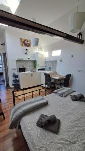 a room with two beds and a kitchen and a table at Apartmán 4you in Buchlovice