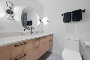 a bathroom with a sink and a mirror at Private Cedar Sauna Retreat - Kitchenette, King Bed, Spa Bath - Deep Cove in North Vancouver +27 photos