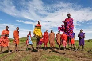 a group of men standing in a field at Empiris homestay in Sekenani +40 photos
