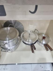 three pots and pans sitting on top of a stove at Elegance Abounds in Qila Malla Singh +25 photos