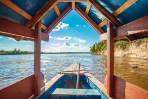 a boat on the water with a view at Panguana Lodge all included in Iquitos