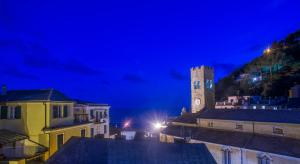 a city at night with a clock tower at Stella Della Marina in Monterosso al Mare