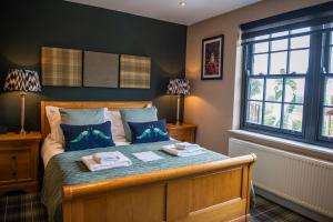 a bedroom with a bed with two towels on it at Blue Bell Country Inn in Knaresborough