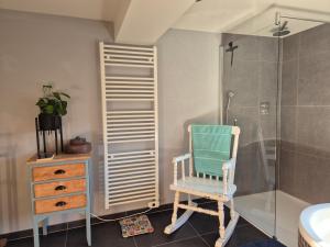 a bathroom with a rocking chair and a shower at Chambre de Amandine à Gerpinnes in Gerpinnes +38 photos