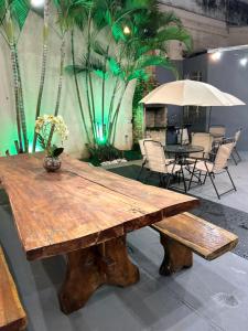 a wooden table with a vase on top of it at Nuhh Hostel & Café in Belo Horizonte