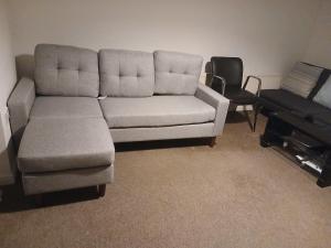 a couch and a chair in a living room at Double room Thornaby train station in Stockton-on-Tees