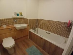 a bathroom with a toilet and a tub and a sink at Double room Thornaby train station in Stockton-on-Tees +7 photos
