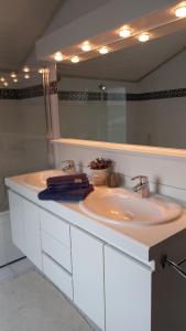 a bathroom with a sink and a mirror at Sea You Soon in De Haan +36 photos