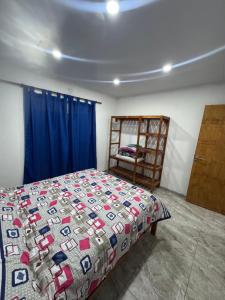 a bedroom with a bed and a chair in it at VEO Apartamentos in Santa Clara del Mar