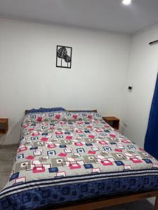 a bed with a quilt on it in a room at VEO Apartamentos in Santa Clara del Mar