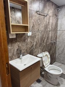 a bathroom with a toilet and a sink at VEO Apartamentos in Santa Clara del Mar