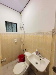 a bathroom with a toilet and a sink at Sim's Agan South Villas in Lagao III +6 photos