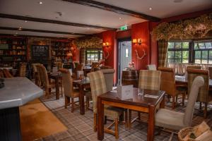 a restaurant with tables and chairs in a room at Blue Bell Country Inn in Knaresborough
