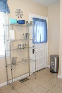 a kitchen with a shelf with bowls on it at Charming 1 BR Apt 6 miles from Downtown! in Cincinnati