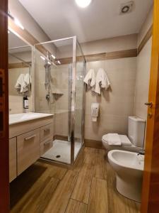 a bathroom with a shower and a toilet and a sink at Hotel Lenotel in Leno +21 photos