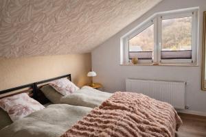 a bedroom with two beds next to a window at Waldpanorama Schildberg in Lügde