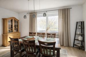 a dining room with a table and chairs and a window at Waldpanorama Schildberg in Lügde