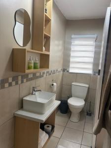 a bathroom with a sink and a toilet at Su Casa Port Alfred in Port Alfred +54 photos
