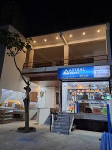 an asian shop with a tree in front of it at MG Stay AYODHYA in Faizābād