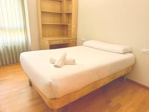 a bed with two towels on it in a room at Av Valladolid 45 in Soria