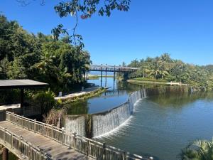 a river with a bridge in the background at Vidanta World in Jarretadera