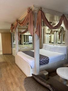 a bedroom with a bed with a canopy at Blue Star Motel in Chicago Ridge