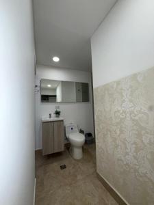 a bathroom with a toilet and a sink at Apartaestudio grupal privado dentro de hotel in Medellín +45 photos