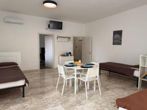 a living room with a table and chairs and a bed at 1402 Rooms in Matera +20 photos
