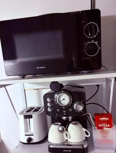 a microwave and a coffee maker on a shelf at Old Tbilisi in Tbilisi City +3 photos