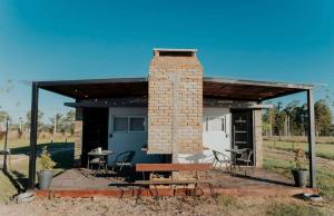 a brick building with a table and a picnic table at La Finca 2 in Mercedes