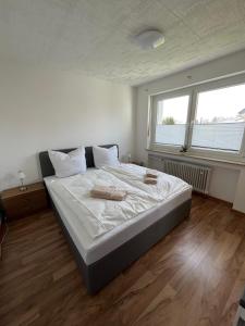 a bedroom with a large bed with two towels on it at Apartment Bielefeld-Brake - nähe Bahnhof -Parken im Hof in Bielefeld