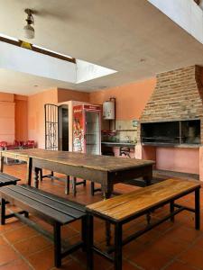 a kitchen with a large wooden table in a room at Complejo Esterlicia in Santa Rosa