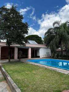 a house with a swimming pool in the yard at Complejo Esterlicia in Santa Rosa