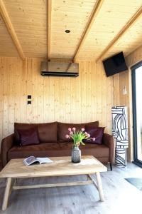 a living room with a couch and a table at Domek Pod Jemiołami - Mały Głęboczek in Mały Głęboczek