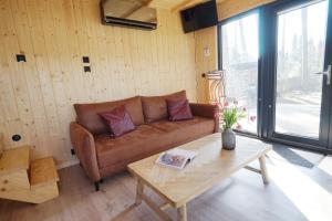 a living room with a couch and a coffee table at Domek Pod Jemiołami - Mały Głęboczek in Mały Głęboczek