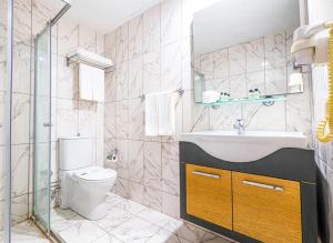 a bathroom with a toilet and a sink and a shower at ESMA CLOVE RESORT&SPa in Eskiömerler +14 photos