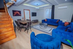 a living room with a blue couch and a table at White Moon Suites in Istanbul