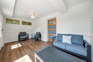 a living room with a blue couch and a table at Emerald Shores - Lakefront, Private Dock & Fire Pit in Moneta +27 photos