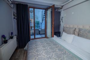 a bedroom with a large bed and a balcony at White Moon Suites in Istanbul