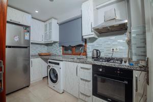 a kitchen with a stove and a washer and dryer at White Moon Suites in Istanbul