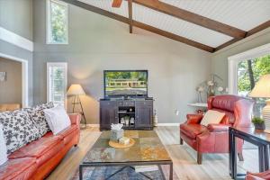 a living room with a couch and a tv at Summer Breeze - Lakefront w/ Private Dock! in Moneta