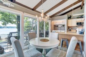 a kitchen and dining room with a table and chairs at Summer Breeze - Lakefront w/ Private Dock! in Moneta