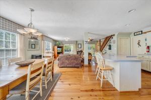 a kitchen and dining room with a table and chairs at Cape Cottage - Private dock & Fire Pit in Moneta